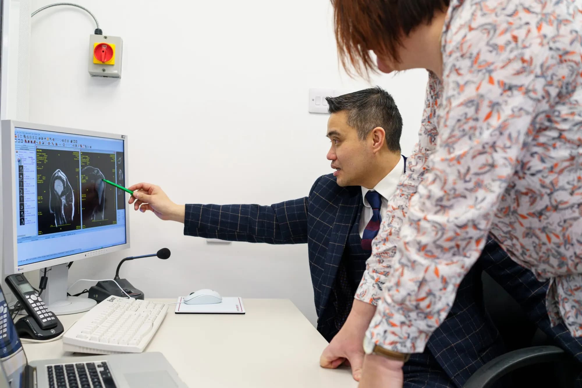 Professor Paul Lee reviewing imaging with a patient