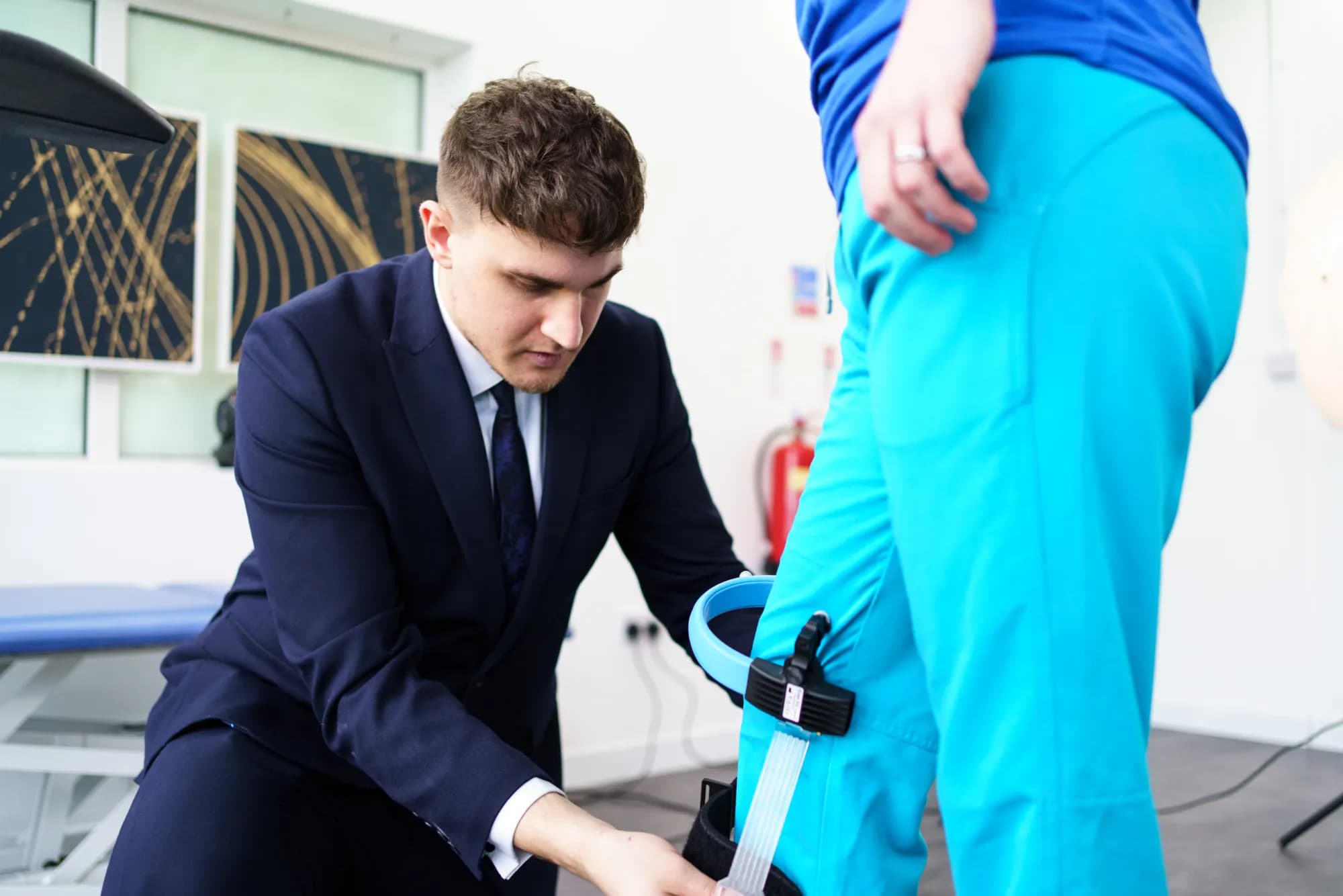 A clinician fitting a knee brace during rehabilitation
